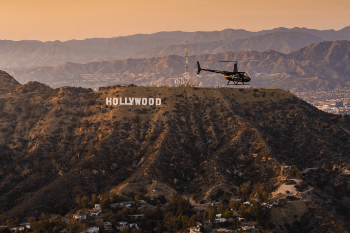 helicopter flying over the hollywood hills
