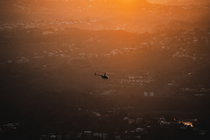 helicopter flying over landscape